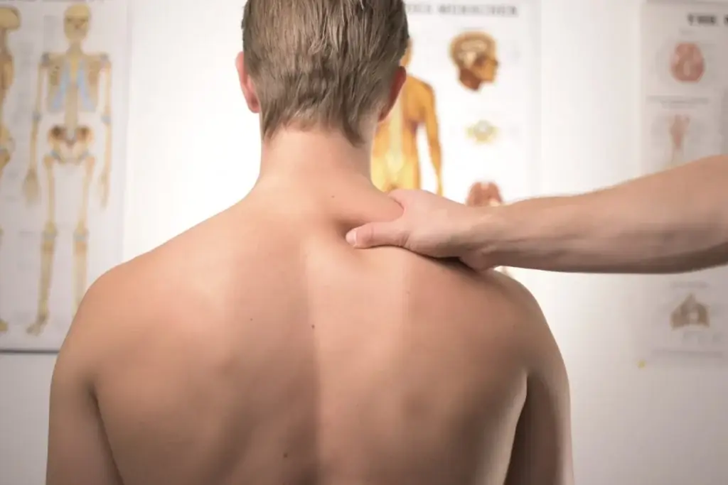 Chiropractor examining a patient's neck and shoulder
